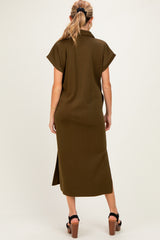 woman wearing an olive green short sleeve maternity dress with a back slit, showing a baby bump
