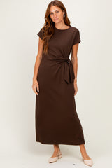 woman wearing a brown short sleeve maxi dress with a side tie detail