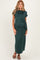 woman wearing a dark green maternity maxi dress with a tie detail, highlighting her baby bump