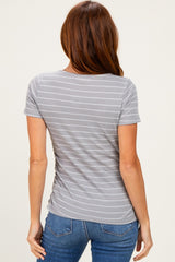 woman wearing a gray striped short sleeve top, shown from the back