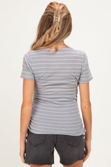 woman wearing a gray striped maternity top seen from the back, with a fitted style and short sleeves