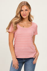 woman wearing a pink striped short sleeve top with a scoop neckline and smiling at the camera