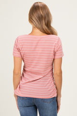 woman wearing a pink striped short sleeve top, viewed from the back.
