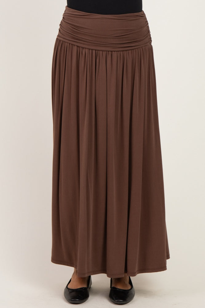 woman wearing a brown maxi skirt with a gathered waistband and flowing silhouette