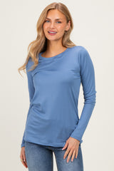 woman wearing a soft blue long sleeve top paired with light blue jeans