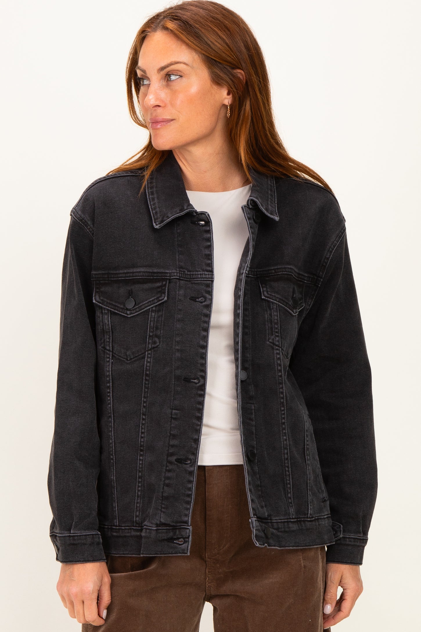 woman wearing a black denim jacket with front pockets and a relaxed fit