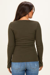 woman wearing a dark olive green long sleeve maternity top with a fitted style, viewed from the back