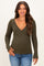 woman wearing an olive green long sleeve maternity top with a v-neck and fitted style