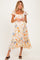 woman wearing a floral maternity dress with a square neckline and ruffled sleeves, showcasing her baby bump