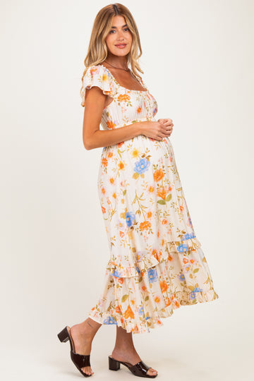 woman wearing a floral maternity dress with short sleeves and ruffled hem, showcasing her baby bump