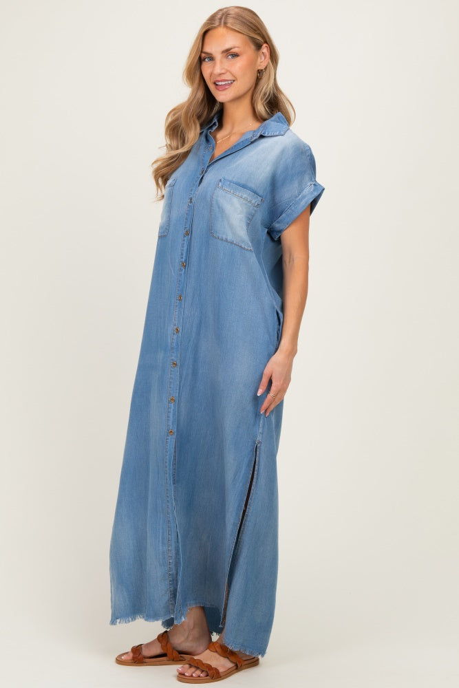 woman wearing a light blue denim maxi shirt dress with short sleeves and side slits, standing side profile