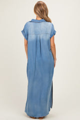 woman wearing a light blue denim maxi dress with short sleeves and a relaxed fit