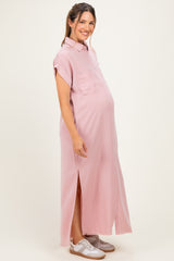 woman wearing a light pink maternity maxi dress with a button-up front and side slits, showing her baby bump