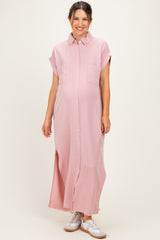 woman wearing a light pink maternity maxi shirt dress with short sleeves and side slits, showing a baby bump