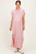 woman wearing a light pink maternity maxi shirt dress with short sleeves and side slits, showing a baby bump