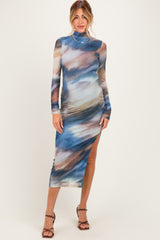 woman wearing a long sleeve blue and multi-colored maternity dress with a side slit and slim fit