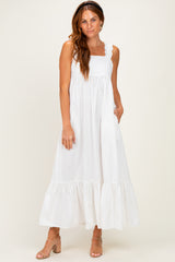 woman wearing a white ruffled strap maxi dress with a tiered hem and pockets