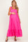 woman wearing a bright pink maternity maxi dress with ruffled straps and a baby bump visible
