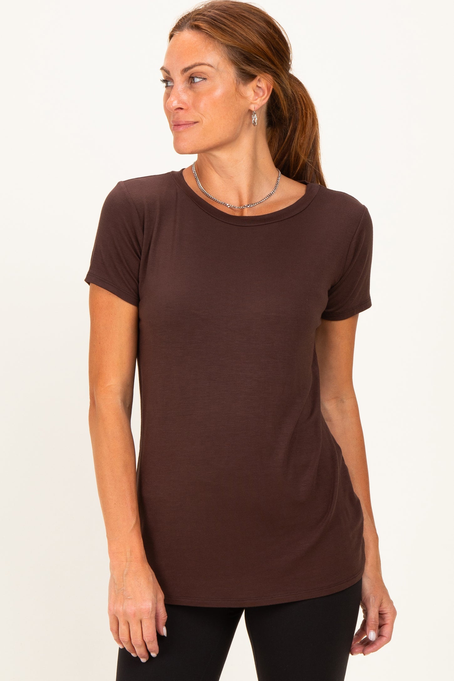 woman wearing a brown short sleeve t-shirt with a round neckline and a relaxed fit