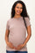 woman wearing a blush short sleeve maternity top and holding her baby bump
