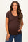 woman wearing a brown short sleeve maternity top and holding her baby bump