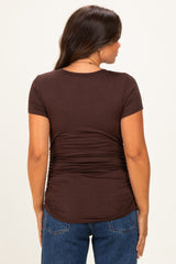 woman wearing a brown short sleeve maternity top with ruching detailing on the back