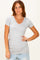 woman wearing a light gray short sleeve v-neck t-shirt with ruching details