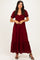 woman wearing a burgundy lace maxi dress with short sleeves and a tiered hem, standing in a neutral background