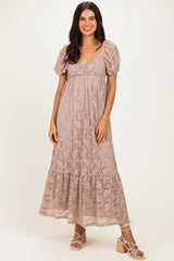 woman wearing a nude lace maxi dress with puff sleeves and a tiered skirt