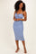 woman wearing a light blue midi dress with adjustable spaghetti straps and a gathered bust detail