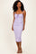 woman wearing a lilac fitted midi dress with adjustable straps and ruching details