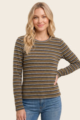 woman wearing a brown and gray striped long sleeve top with a crew neckline and a relaxed fit paired with blue jeans