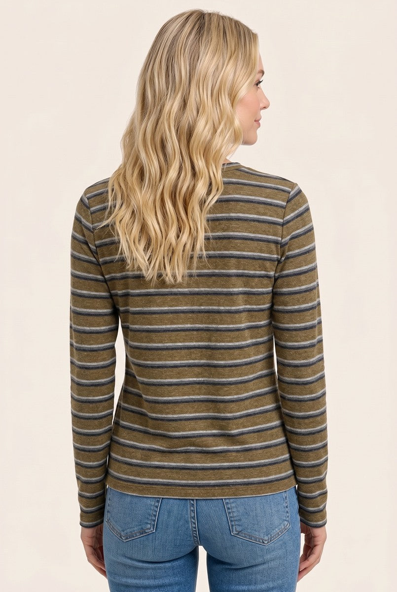 woman wearing a brown and gray striped long sleeve top, seen from the back with wavy blonde hair