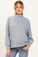 woman wearing a striped maternity top with a funnel neck and relaxed fit