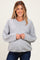 woman wearing a gray maternity cardigan with button closure and relaxed fit, smiling while holding her baby bump