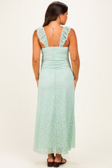 woman wearing a mint green lace maternity maxi dress with ruffle straps, showing a side view and back detail