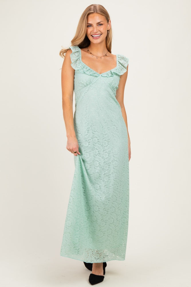 woman wearing a mint green lace maxi dress with ruffle details on the neckline and elegant fit