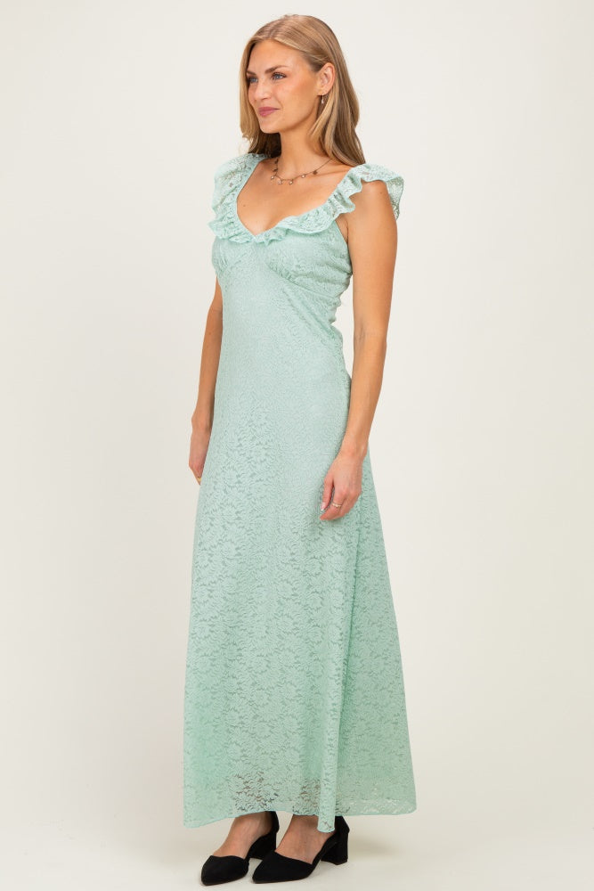 woman wearing a mint green lace maxi dress with ruffle shoulder details and a fitted silhouette