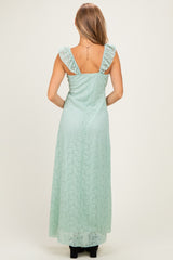 woman wearing a mint green lace maxi dress with ruffled straps, seen from the back