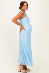 woman wearing a light blue lace maternity maxi dress and showcasing her baby bump