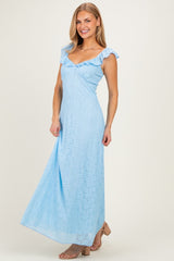 woman wearing a light blue lace maxi dress with ruffled straps and a v-neckline