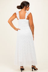 woman wearing a white lace maternity maxi dress with ruffled sleeves, showcasing a fitted bodice and flowing skirt