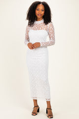 woman wearing a white lace long sleeve midi dress with a fitted silhouette and sheer details