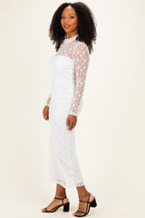 woman wearing a white long sleeve sheer dress with star pattern and form-fitting silhouette
