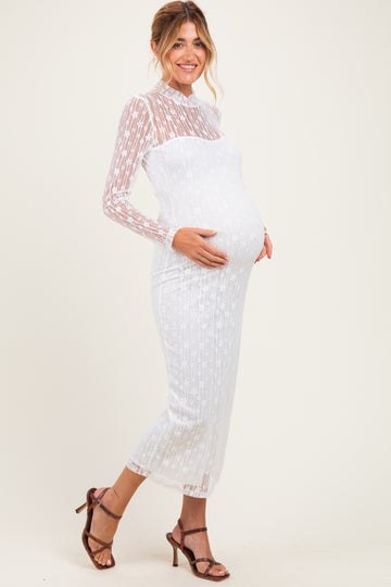 woman wearing a sheer white long sleeve maternity dress highlighting her baby bump paired with strappy heels