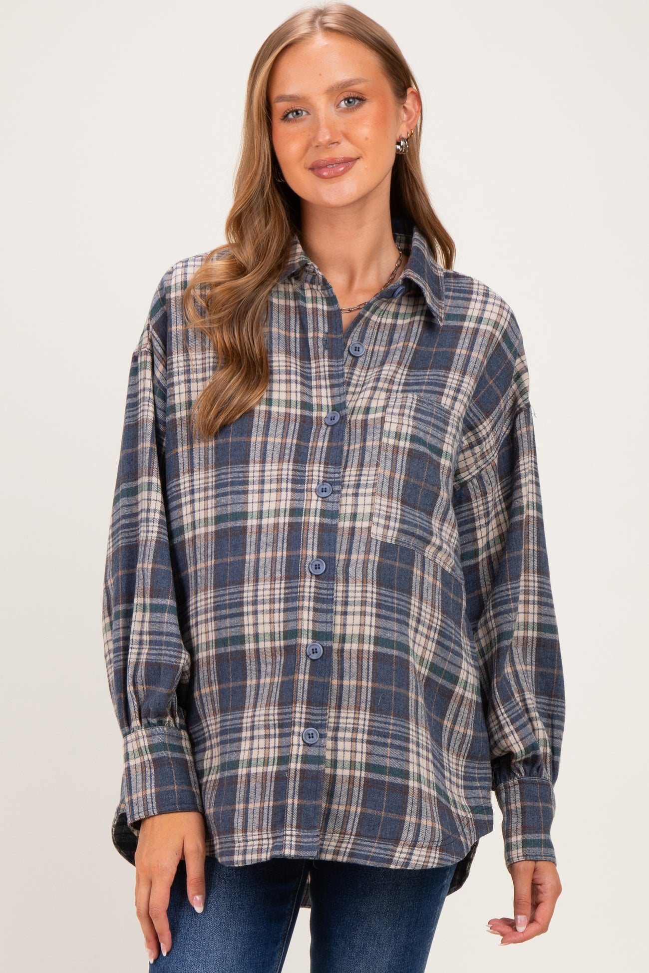 woman wearing a blue and gray plaid maternity shirt with button closure and relaxed fit
