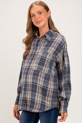 woman wearing a navy and green plaid maternity shirt with a visible baby bump