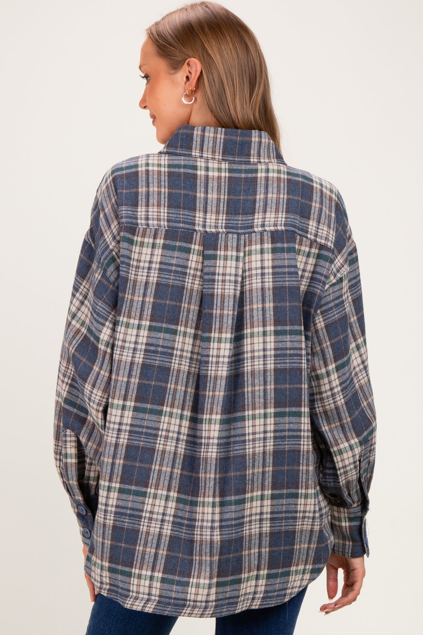 woman wearing a blue plaid maternity shirt with a relaxed fit, viewed from the back