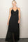woman wearing a black maxi dress with spaghetti straps and gathered detailing at the bodice