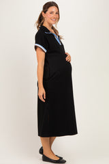 woman wearing a black maternity dress with blue collar accents and a visible baby bump